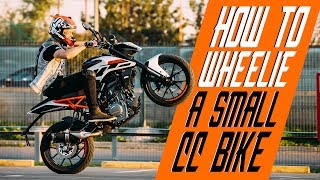 How to wheelie a small cc bike  RokON VLOG 25 [upl. by Rena936]